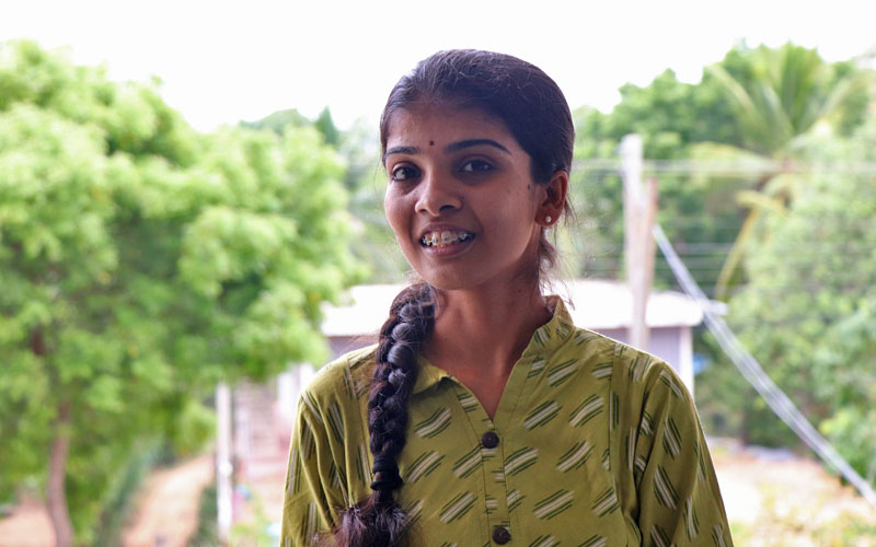 Anojitha is a young Sri Lankan woman wearing a green blouse and a side braid.