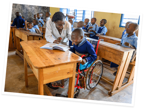 Abraham thrives in the classroom, sitting in his World Vision-provided wheelchair.