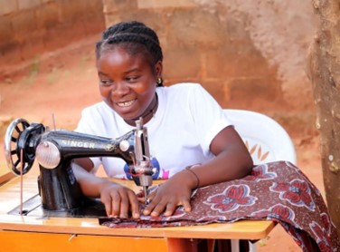 A young woman uses a sewing machine.