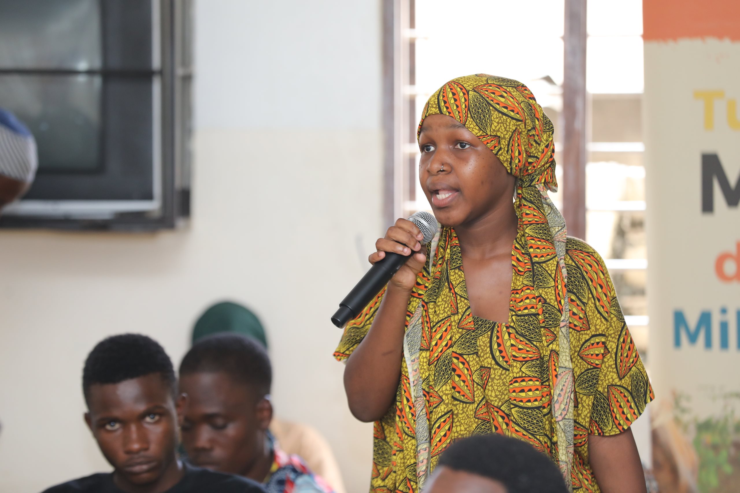 A girl speaks into a mic.